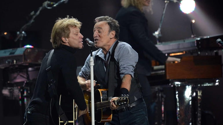 Jon Bon Jovi, left, and Bruce Springsteen perform during 12-12-12...