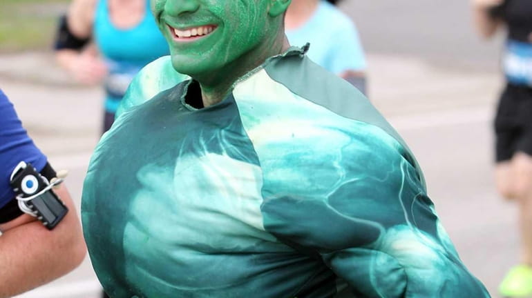 The first runners, including one dressed as "The Hulk," leave...