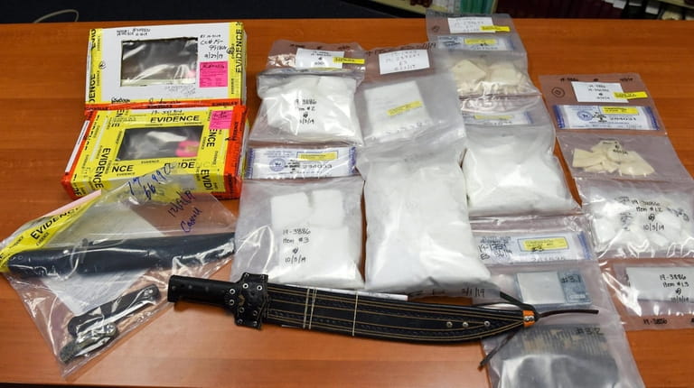 Seized weapons and drugs on display at Friday's news conference...