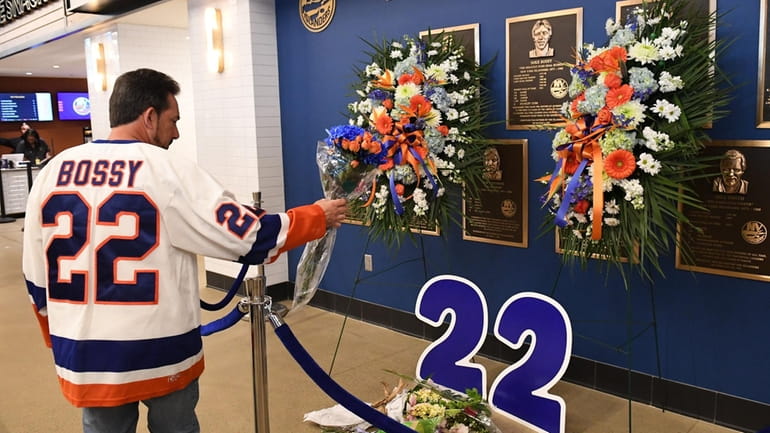Fans leave flowers by the Hall of Fame Mike Bossy...