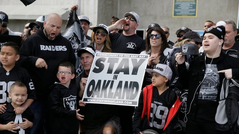Oakland Raiders fans gather for a picture before the start...