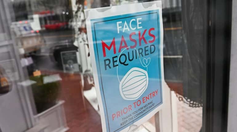 A sign greets customers at a business on Main Street in Huntington Village...