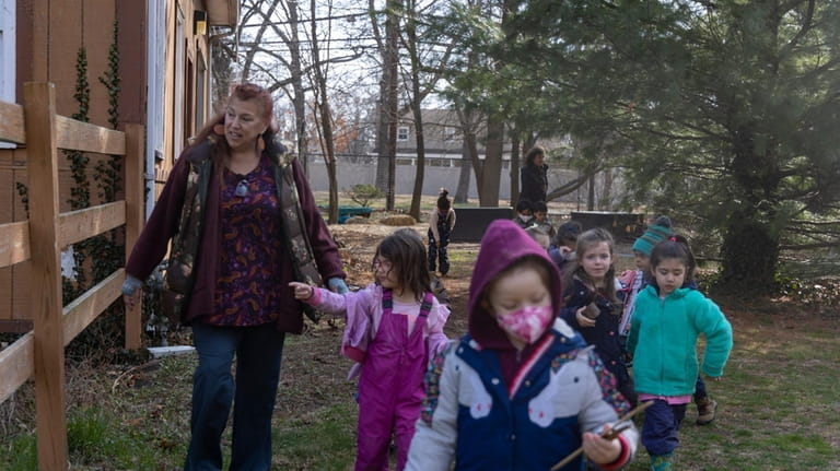Teacher Michele Anselmo instructs students at the outdoor nature-based preschool...