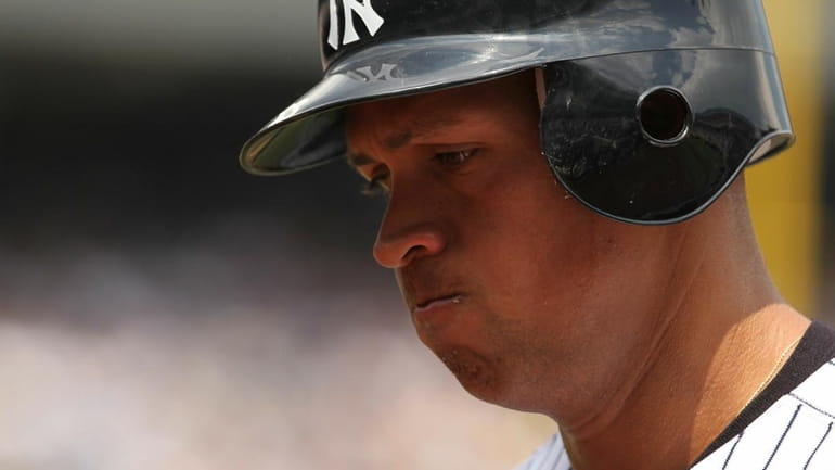 Alex Rodriguez of the New York Yankees reacts after flying...