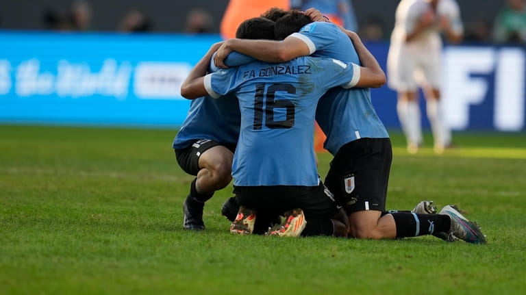 Players of Uruguay celebrate their team's win over Israel at...