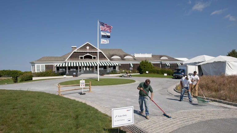 Workers in front of the clubhouse of the Atlantic Golf...