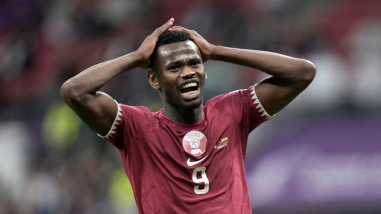 Qatar's Mohammed Muntari reacts after missing a chance to score...