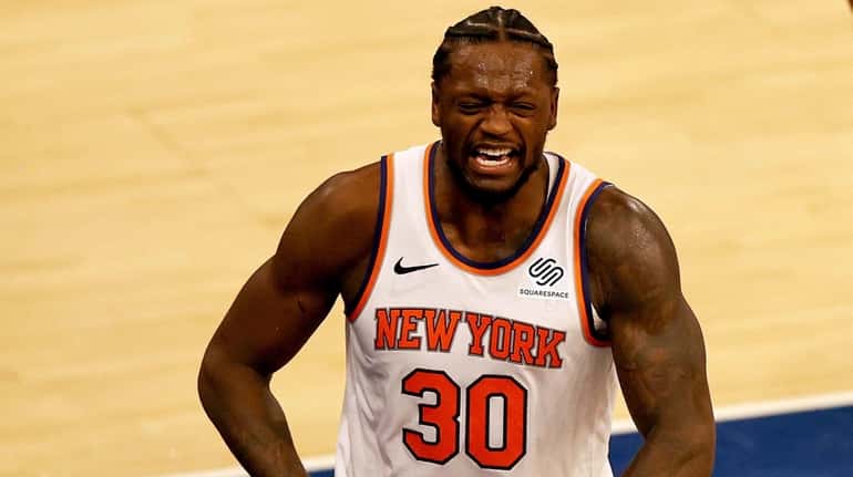 The Knicks' Julius Randle celebrates after drawing a foul late...