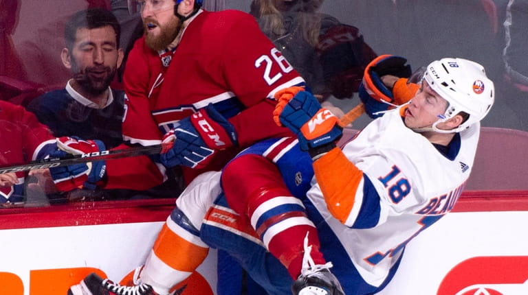 Montreal Canadiens' Jeff Petry gets tangled up with New York...