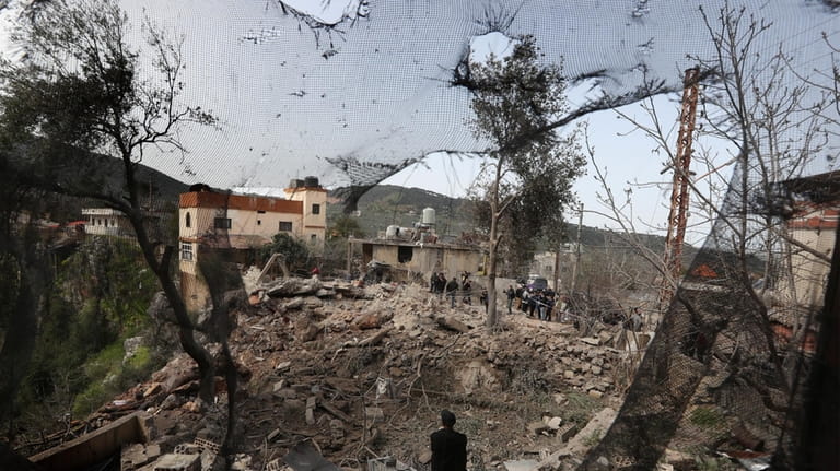 People gather on the rubble of a paramedic center that...