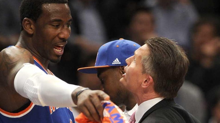 Amar'e Stoudemire trying to explain to coach Phil Weber what...