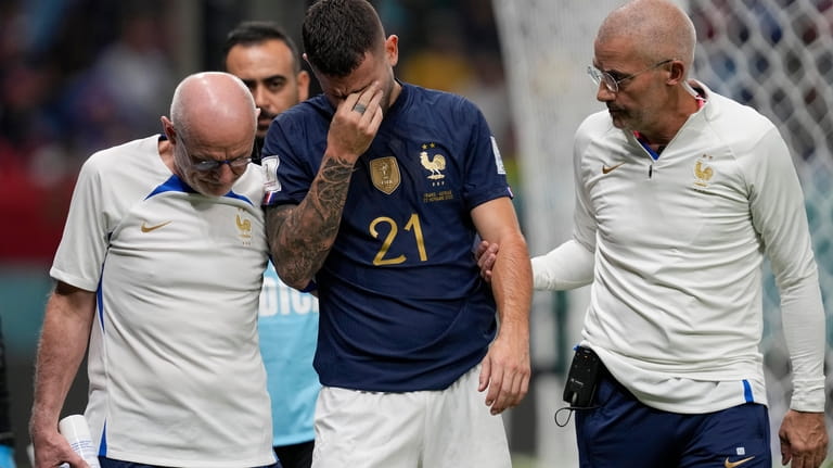 France's Lucas Hernandez leaves the pitch after getting injured during...