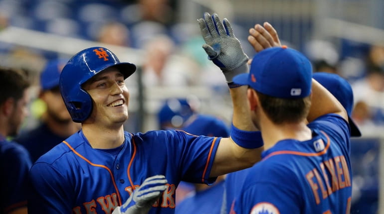 Mets' Brandon Nimmo celebrates with teammates after his seventh-inning home...