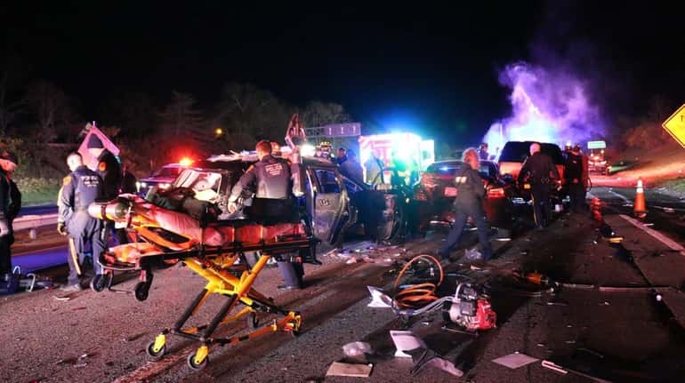 Emergency workers respond to a six-vehicle crash Thursday night on...