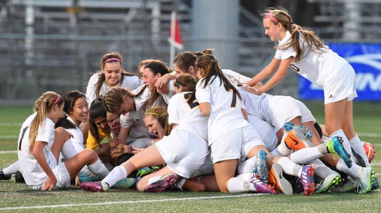 Massapequa players celebrate their victory over Baldwinsville after the state...
