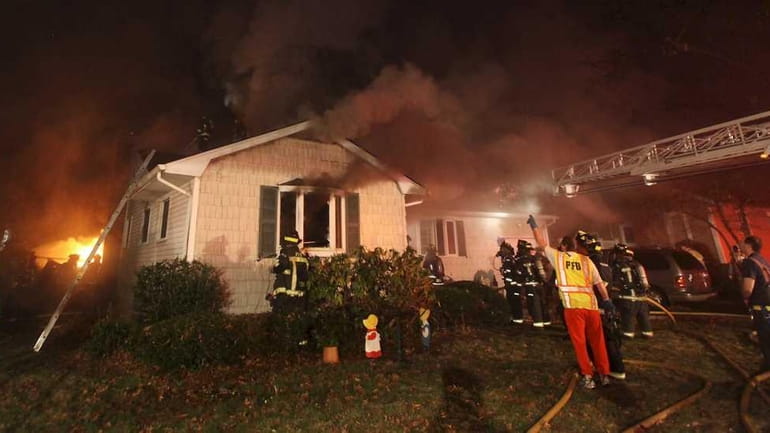 Two firefighters suffered minor injuries battling a house fire in...
