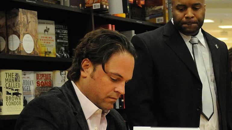 Retired All-Star catcher Mike Piazza signs copies of his autobiography,...