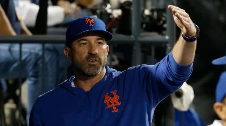 Manager Mickey Callaway #36 of the Mets looks on from...