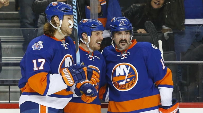 Casey Cizikas, center, of the New York Islanders celebrates his...