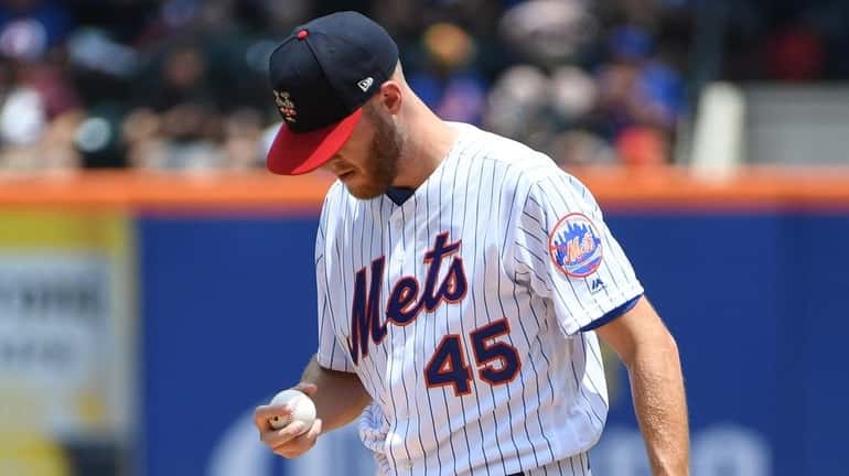 Mets starting pitcher Zack Wheeler reacts against the Phillies during...