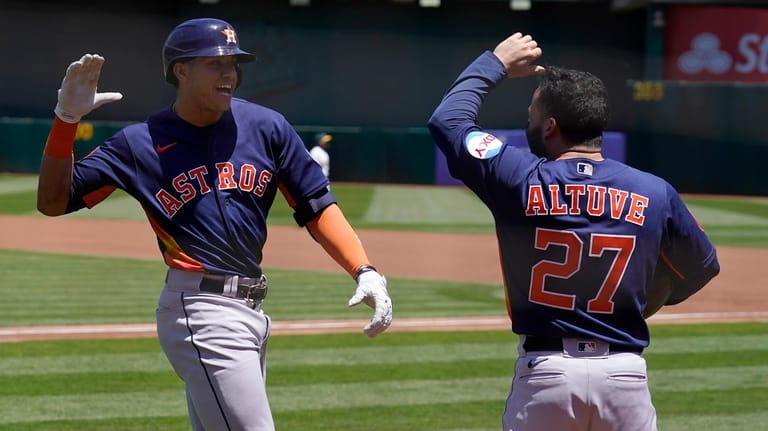 Houston Astros' Jeremy Pena, left, celebrates after hitting a two-run...
