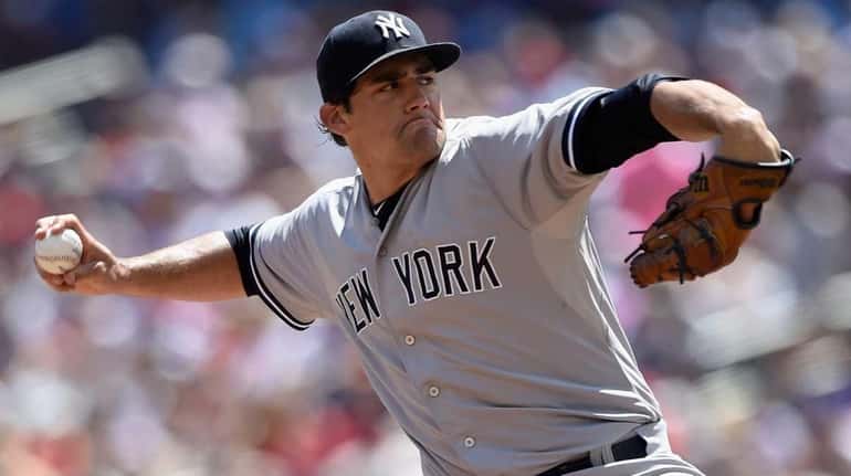 Nathan Eovaldi #30 of the New York Yankees delivers a...