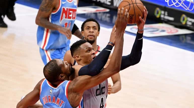 Russell Westbrook #4 of the Washington Wizards shoots in front...