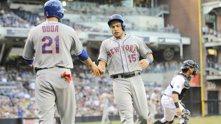 Travis d'Arnaud of the Mets is congratulated by Lucas Duda...