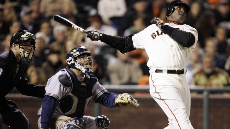 Former San Francisco Giants outfielder Barry Bonds, right, hits his...