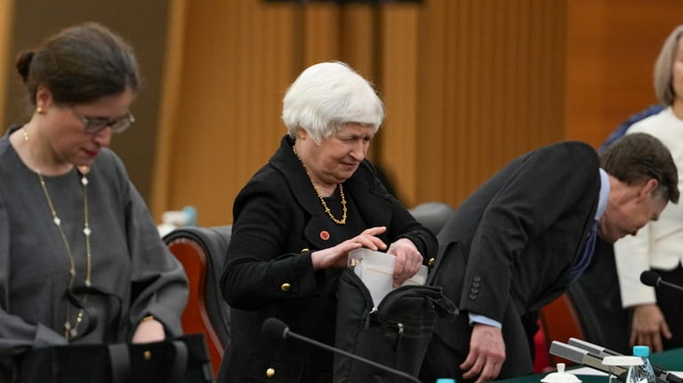 U.S. Treasury Secretary Janet Yellen, center, prepares her documents as...