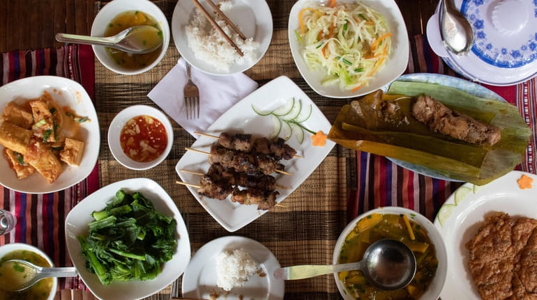 A lunch at homestay lodging includes grilled pork skewers, pork...
