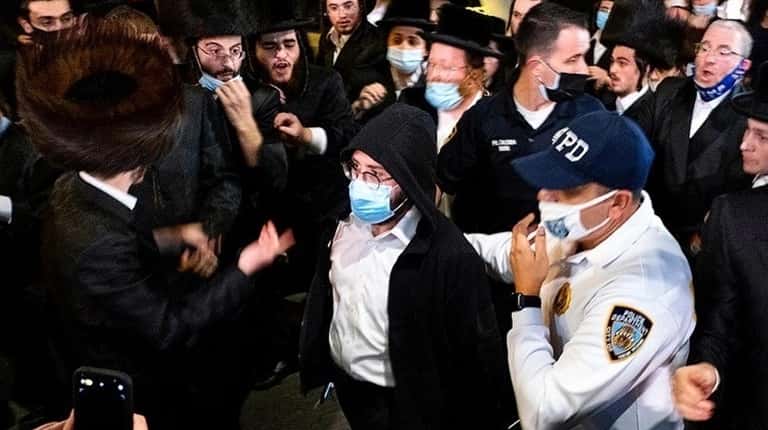 Jacob Kornbluh, a reporter for the Jewish Insider, is escorted...