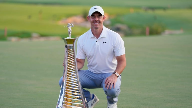 Rory McIlroy of Northern Ireland poses with his Race to...