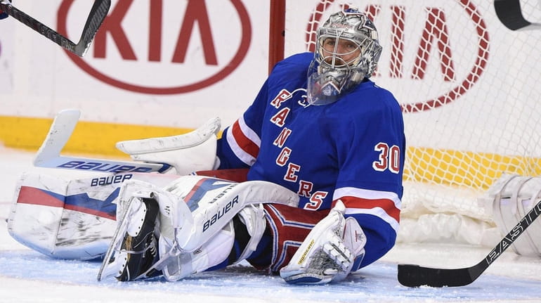 New York Rangers goalie Henrik Lundqvist sits in front of...