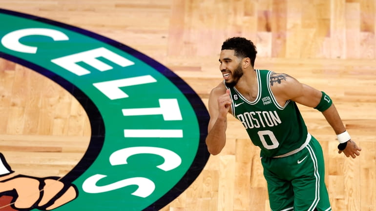 Boston Celtics forward Jayson Tatum heads the other way after...