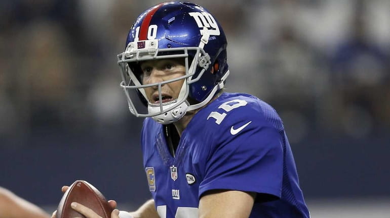 New York Giants quarterback Eli Manning (10) scrambles with the...