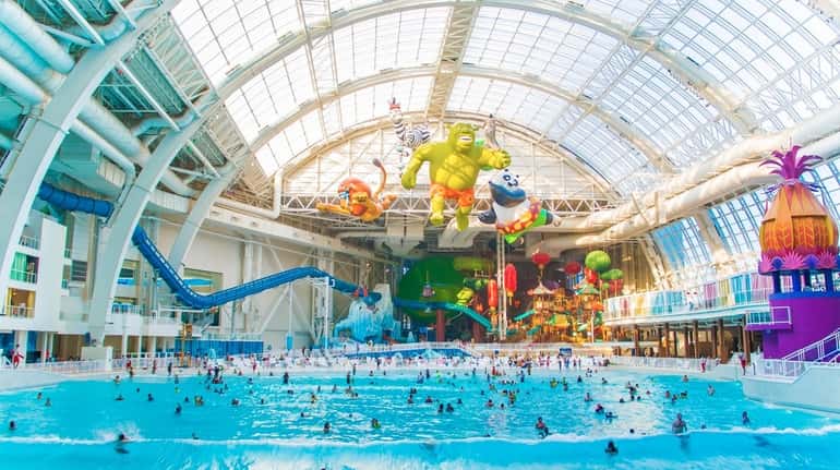 People play among the waves in this 1.6-million gallon heated...