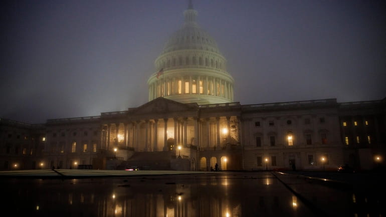 Fog envelopes the U.S. Capitol building in the early morning...