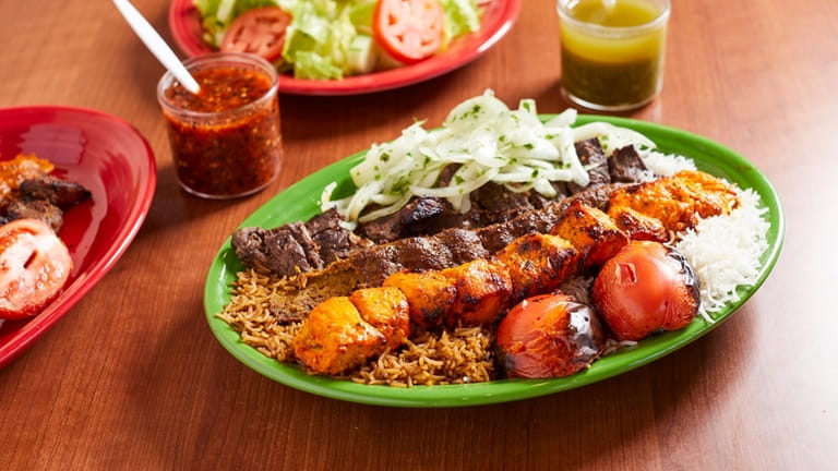 Chicken kabab, lamb tikka and beef kobideh kababs served with...