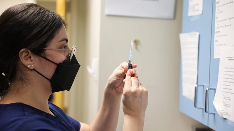 Wendy Gonzalez prepares a flu shot at Huntington Village Pediatrics in Huntington...
