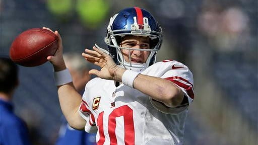 Eli Manning throws during pregame activities before a game against...