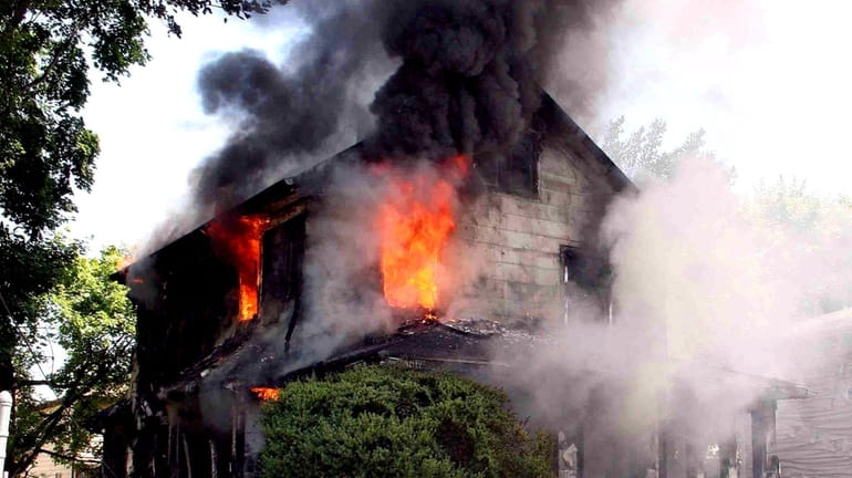 A fire rips through a Roosevelt home Tuesday. (June 8,...