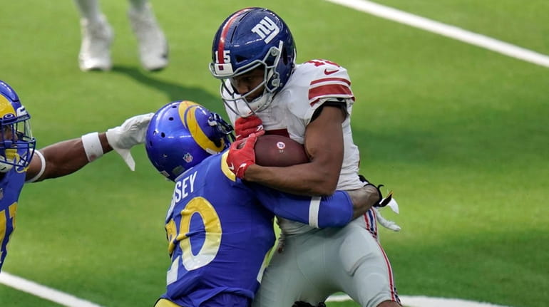 Giants wide receiver Golden Tate, right, is tackled by Rams cornerback...