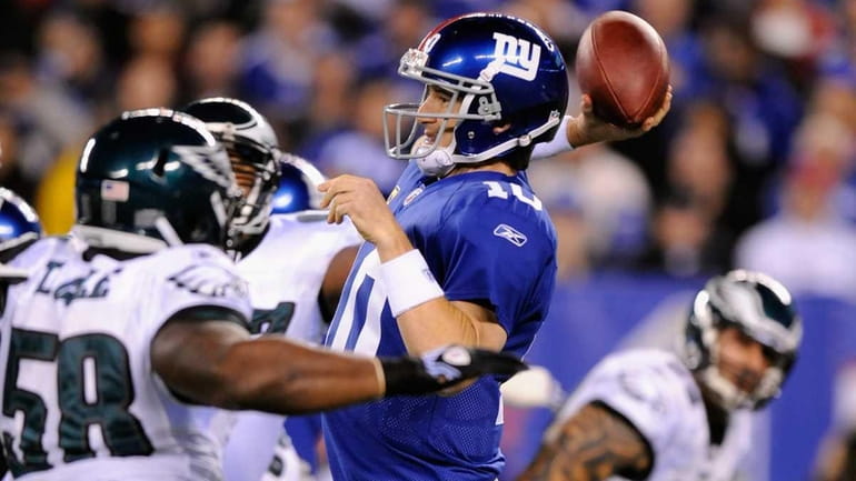 Eli Manning #10 of the New York Giants throws a...