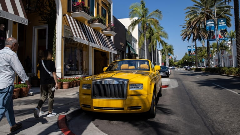 Tourists walk on Rodeo Drive of Beverly Hills in Los...