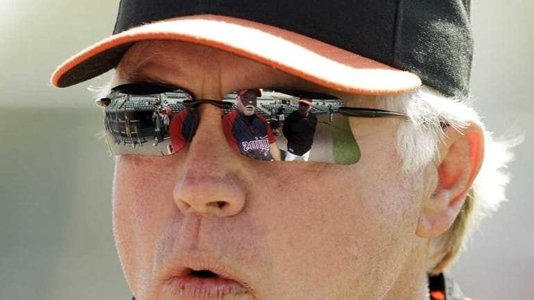 Minnesota Twins manager Ron Gardenhire is reflected in the sunglasses...