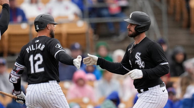 Chicago White Sox's Paul DeJong, right, celebrates after his two-run...