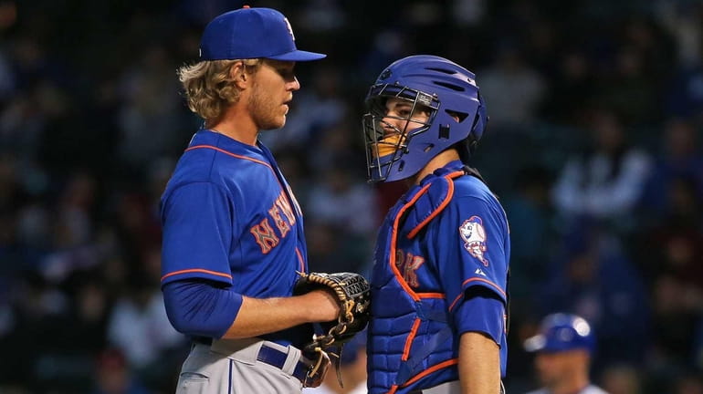 Starting pitcher Noah Syndergaard of the New York Mets takes...