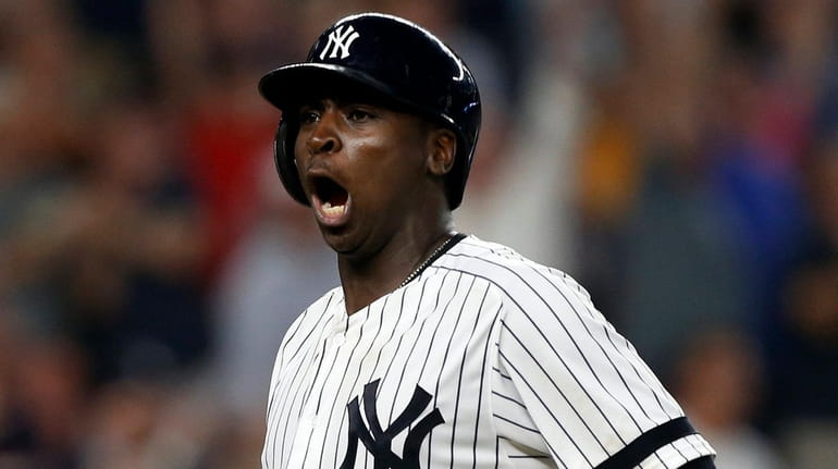 Yankees shortstop Didi Gregorius reacts after his eighth-inning grand slam...
