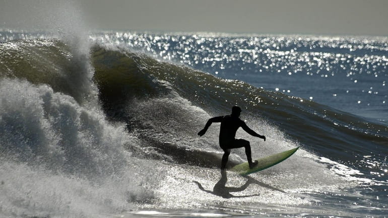 This surfer catches a wave in Long Beach.